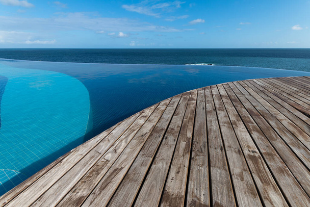 Infinity pool with views of the sea and blue sky - Photo, Image