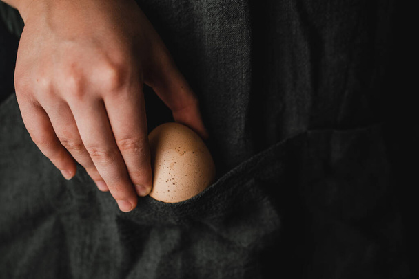 Fresh organic eggs on the hands of young farmers - 写真・画像