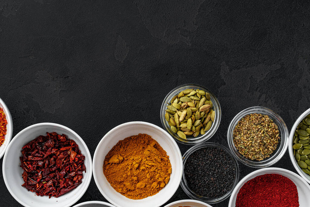 Bowls with assorted spices on dark background - Foto, imagen