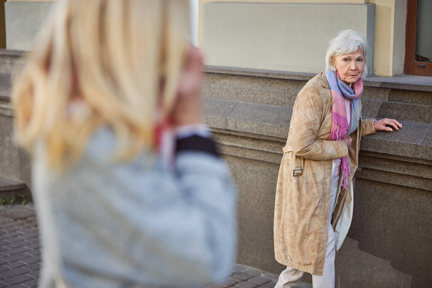 Elderly woman feeling ill in the outdoors - Valokuva, kuva