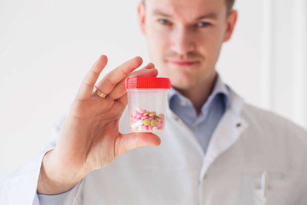 Close up doctor hands holding with jar of capsules - Foto, Imagem