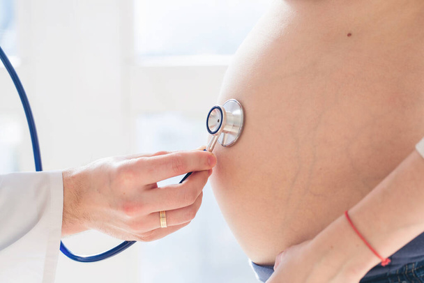 Healthcare, medical: Doctor examining a pregnant woman. - 写真・画像