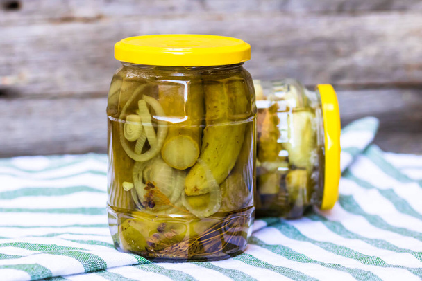 Glass jar with pickles isolated. Preserved food concept, canned vegetables isolated in a rustic composition. - Photo, Image