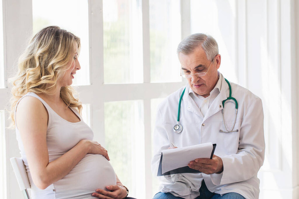 Pregnant woman visiting experienced doctor - 写真・画像