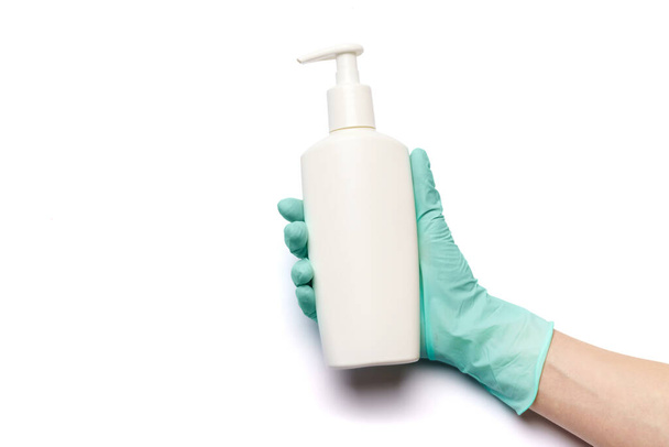 Female hand in latex rubber glove and hand sanitizer spray dispenser isolated on white background with clipping path - Photo, image