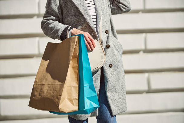 Woman holding shopping bags in the city - Photo, Image