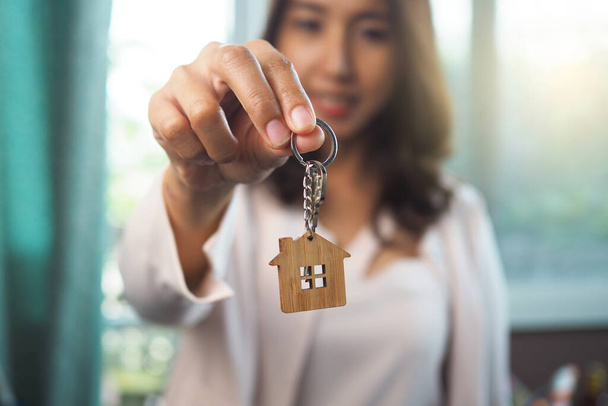 Ev satış temsilcileri ev anahtarları veriyor. Bir ev kiralamak, satın almak ve satmak - Fotoğraf, Görsel