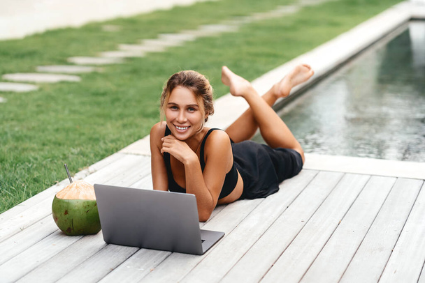 Woman freelance work typing on laptop with fresh coconut . - Fotografie, Obrázek