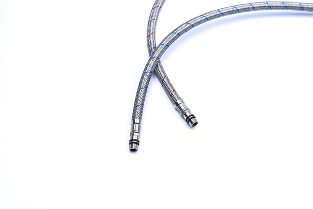 Hoses for connecting a tap on a white background with a place for an inscription or text. - Photo, Image