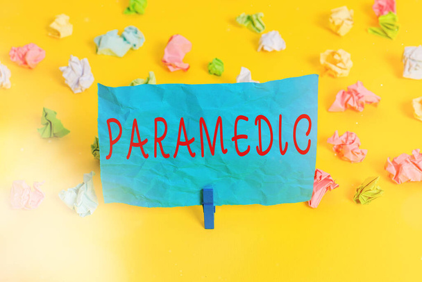 Conceptual hand writing showing Paramedic. Business photo showcasing a health worker having an expertise in emergency medical work Colored crumpled paper empty reminder white floor clothespin. - Photo, Image