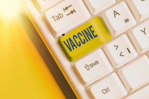 Writing note showing Vaccine. Business photo showcasing preparation of killed microorganisms or living attenuated organisms White pc keyboard with empty note paper above white key copy space. - Photo, Image