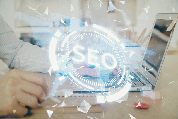 Double exposure of seo icon with man working on computer on background. Concept of search engine optimization. - Foto, immagini