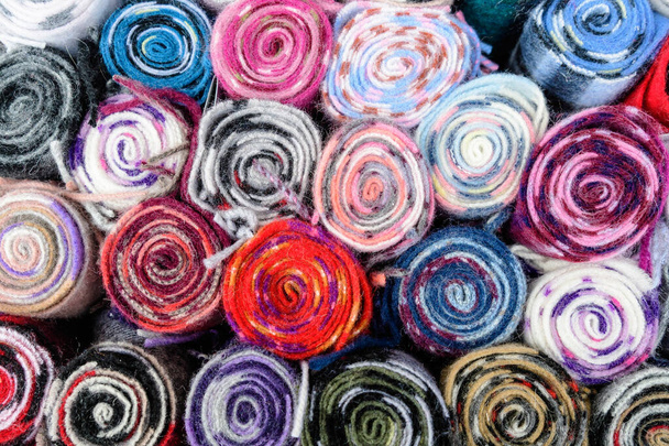 Mixed colored wool scarfs displayed for sale at a traditional store in Edinburgh, United Kingdom - Фото, зображення