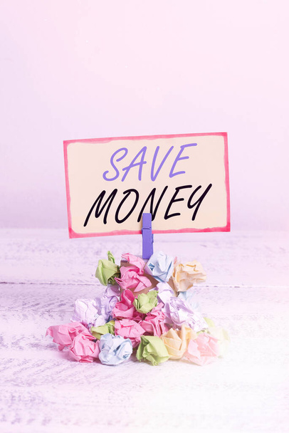 Writing note showing Save Money. Business photo showcasing to budget or put money aside for the future or emergency Reminder pile colored crumpled paper clothespin wooden space. - Φωτογραφία, εικόνα