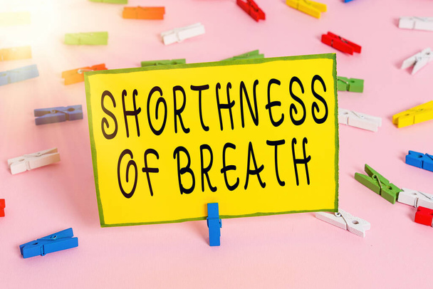 Word writing text Shorthness Of Breath. Business concept for intense tightening of the airways causing breathing difficulty Colored clothespin papers empty reminder pink floor background office pin. - Photo, Image