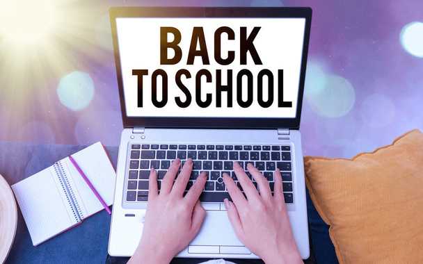 Conceptual hand writing showing Back To School. Business photo showcasing is the period relating to the start of a new school year Modern gadgets white screen under colorful bokeh background. - 写真・画像