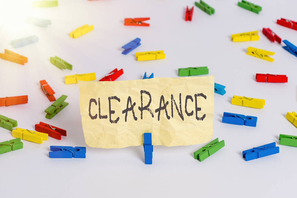 Handwriting text writing Clearance. Concept meaning action or method to remove or distribute something or dispersing Colored clothespin papers empty reminder white floor background office. - Photo, Image