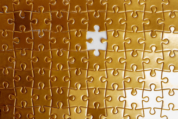 Missing jigsaw gold puzzle piece, gold and money concept - Photo, Image