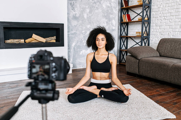 An African-American woman records yoga classes - Foto, Imagen