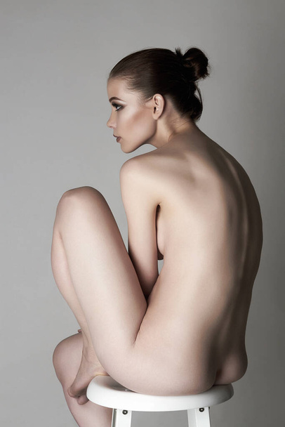 sensual beautiful naked girl. female back. sitting nude woman - Photo, Image