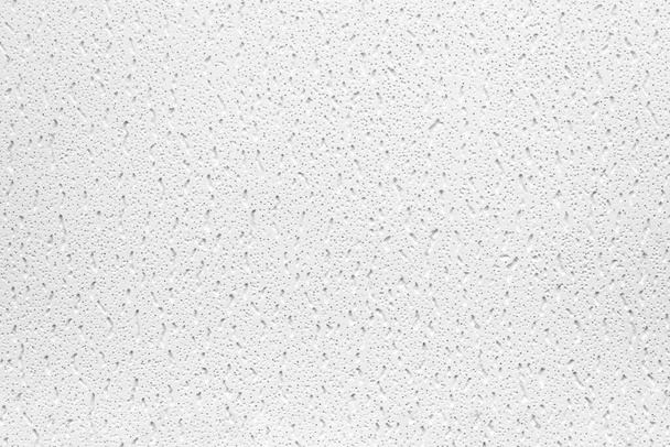 Image couleur horizontale avec vue de face d'un gros plan d'un fond ou d'une texture blanche. Matériau en plâtre ou en fonte. Surface irrégulière grise et noire poreuse. - Photo, image
