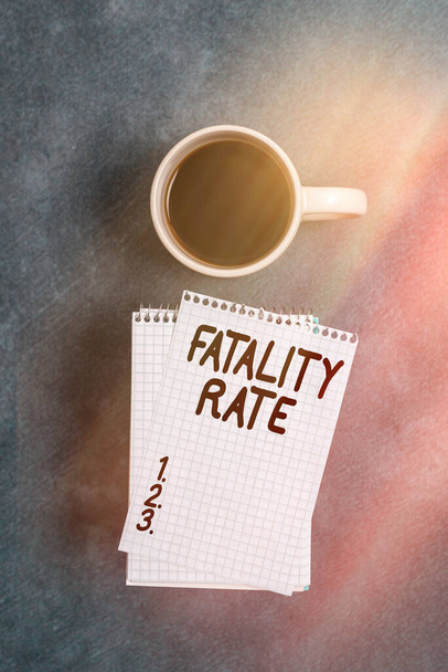 Conceptual hand writing showing Fatality Rate. Business photo text calculated number of deaths over a specific range of period Paper accessories with smartphone arranged on different background. - Photo, Image