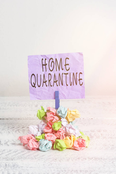 Writing note showing Home Quarantine. Business photo showcasing Encountered a possible exposure from the public for observation Reminder pile colored crumpled paper clothespin wooden space. - Foto, Imagem