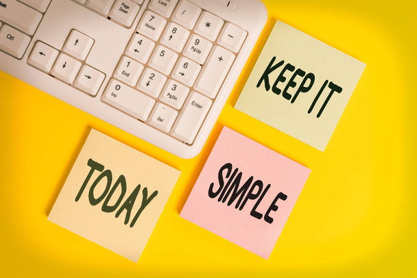 Handwriting text Keep It Simple. Concept meaning ask something easy understand not go into too much detail Colored empty papers with copy space on the yellow background table with pc keyboard. - Photo, Image