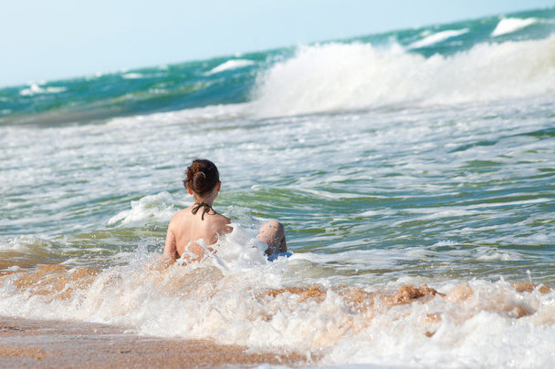 Happy girl splashing in the waves - Photo, image