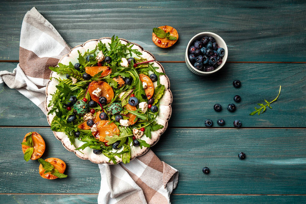 Vibrant grilled peach salad with blueberries and creamy goat cheese, Healthy vegan salad, place for text, top view, - Photo, Image