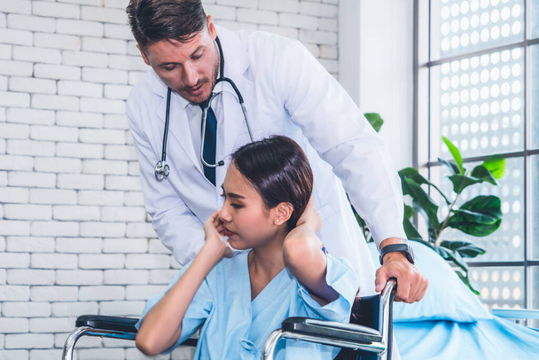 Doctor in professional uniform examining patient at hospital or medical clinic. Health care , medical and doctor staff service concept. - Photo, Image