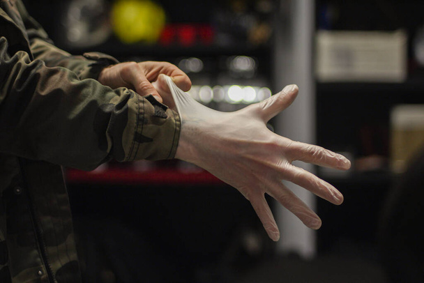 Hands putting on rubber gloves to protect against coronavirus - Foto, Imagem