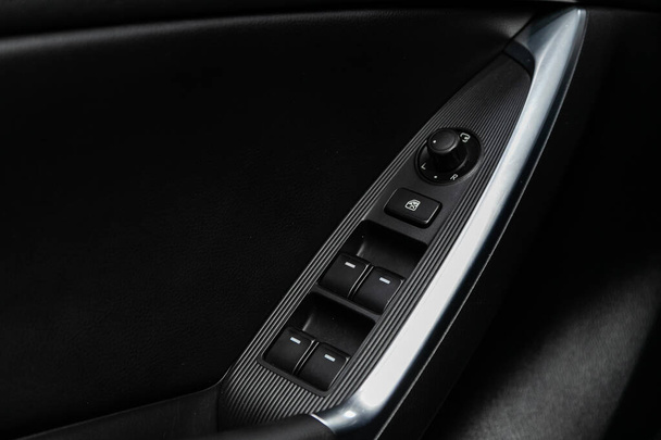 Novosibirsk/ Russia  June 23 2020: Mazda CX-5, closeup of a door control panel in a new car. Arm rest with window control panel, door lock button, and mirror control   - Φωτογραφία, εικόνα