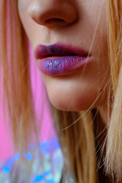 Close up of female lips with bright lipstick. Makeup in pink and purple shades. - Foto, immagini