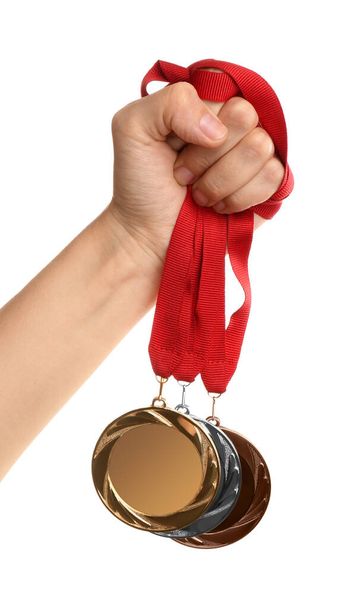 Woman holding medals on white background, closeup. Space for design - Foto, Imagem