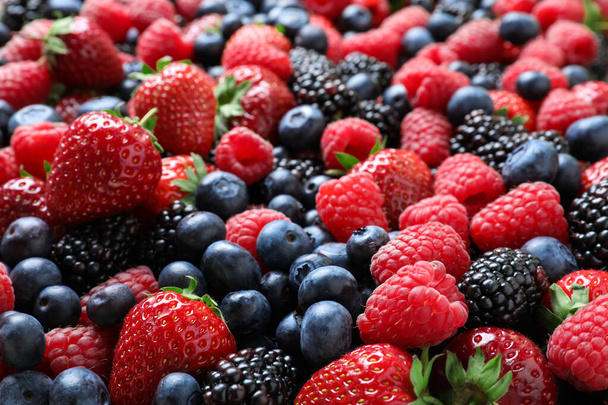 Mix of different ripe tasty berries as background, closeup view - Foto, Imagen