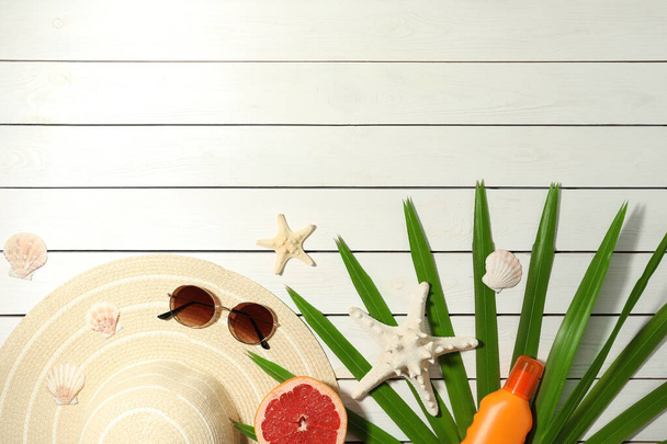 Flat lay composition with grapefruit and beach objects on white wooden background. Space for text - Фото, изображение