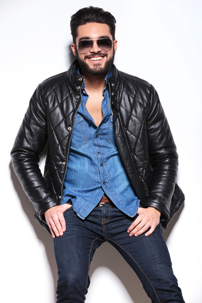smiling young man in sunglasses and leather jacket - Photo, Image