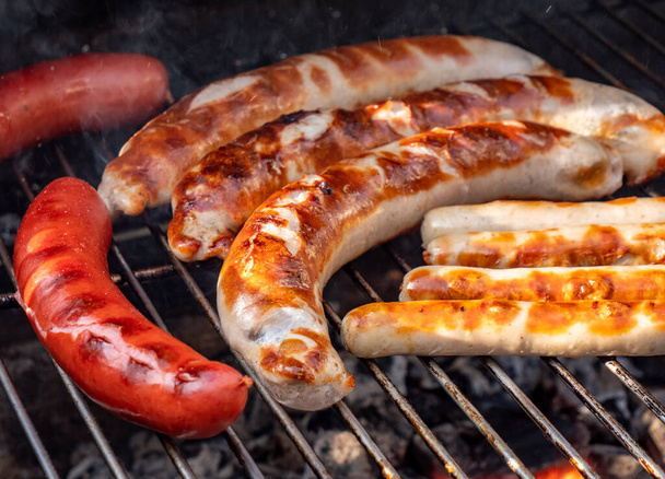 Barbecue with sausage in the garden - Foto, Bild