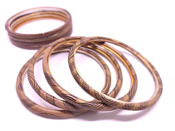 Multicolored Bangles isolated on white background. Selective focus. Bangles are traditionally rigid bracelets, originating from the Indian subcontinent. - Photo, Image