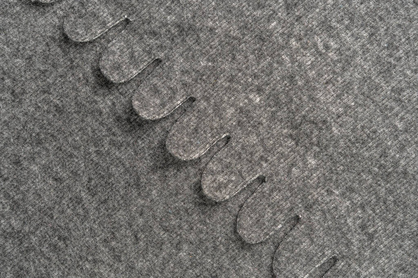 Material quente cinza lanoso close-up com dobras e padrão. Fundo abstrato. O conceito de conforto e calor. Espaço de cópia
 - Foto, Imagem
