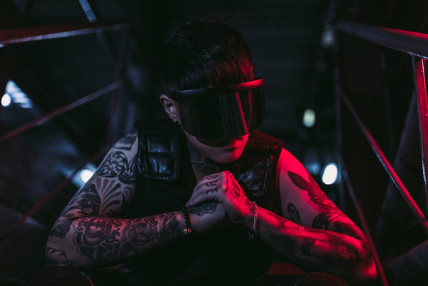 Cyberpunk style. Tattooed guy in one city. Cyber glasses. - Photo, Image