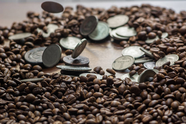 Soviet Union coins fall on coffee beans. Two dollars in silver. Charms and bark of the Mamvri oak. Washingtonia Leaflet. Flatley. Souvenirs on a dark background. Brown background - Photo, Image