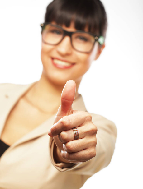 Happy businesswoman showing thumb up over white background - Foto, afbeelding