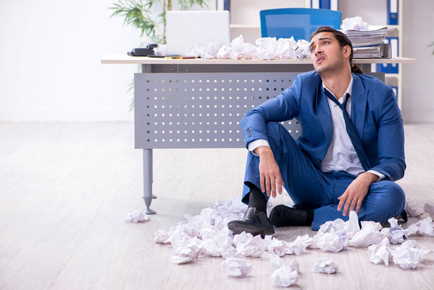 Businessman rejecting new ideas with lots of papers - Photo, Image
