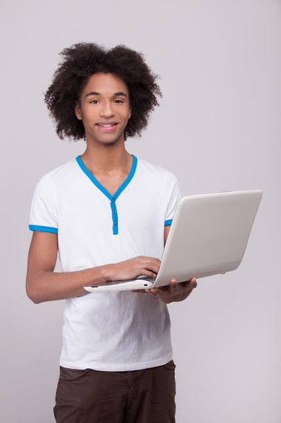 Teenage boy with laptop. - Zdjęcie, obraz