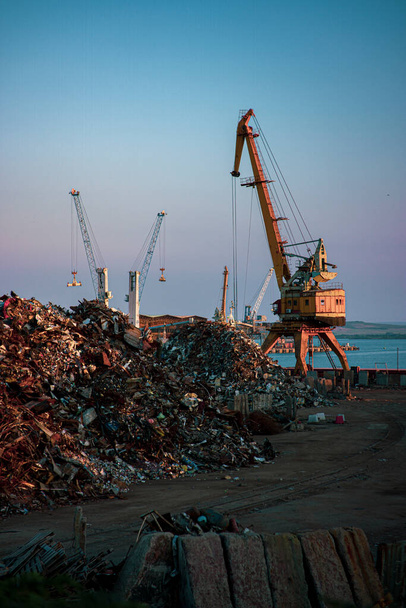 Garbage pile in trash dump or junkyard, metal crane garbage consumption junkyard scarp, Global warming, Ecosystem and environment concepts and background. - Photo, Image