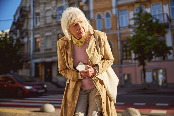 Portrait of elderly woman while feeling stomach ache - Fotografie, Obrázek