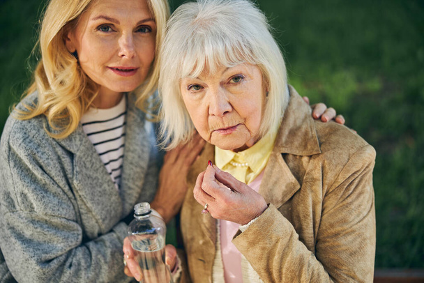 Portrait of two beautiful mature women posing to the camera - Photo, image