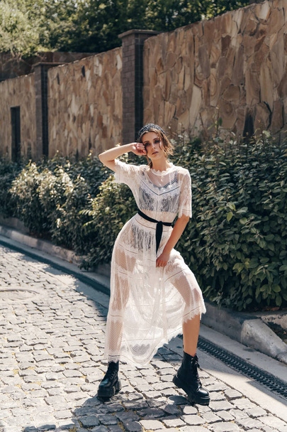 fashion outdoor photo of beautiful woman with dark hair in elegant white dress and accessories - Valokuva, kuva
